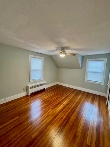 a view of a room with wooden floor and window