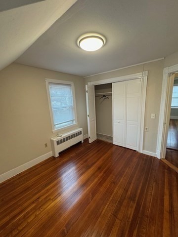 52 Curve Street, Unit 52 Dedham, MA 02026 - Photo 7 of 11 wooden floor in an empty room with a window