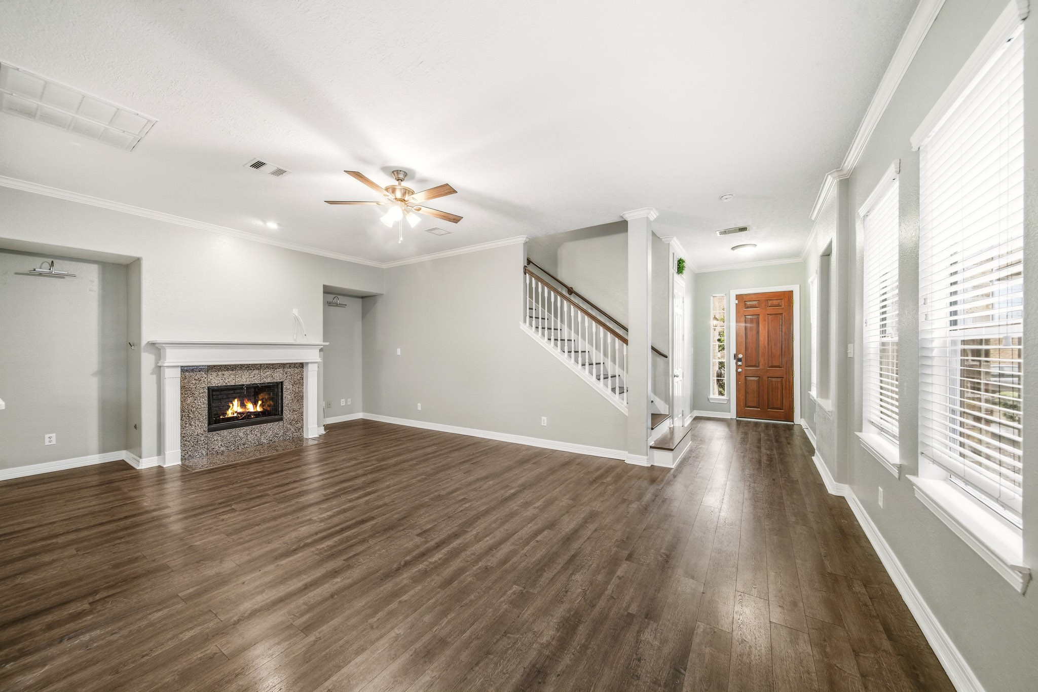 2711 Wallingford Pines Houston, TX 77042 - Photo 4 of 8 wooden floor fireplace and windows in an empty room
