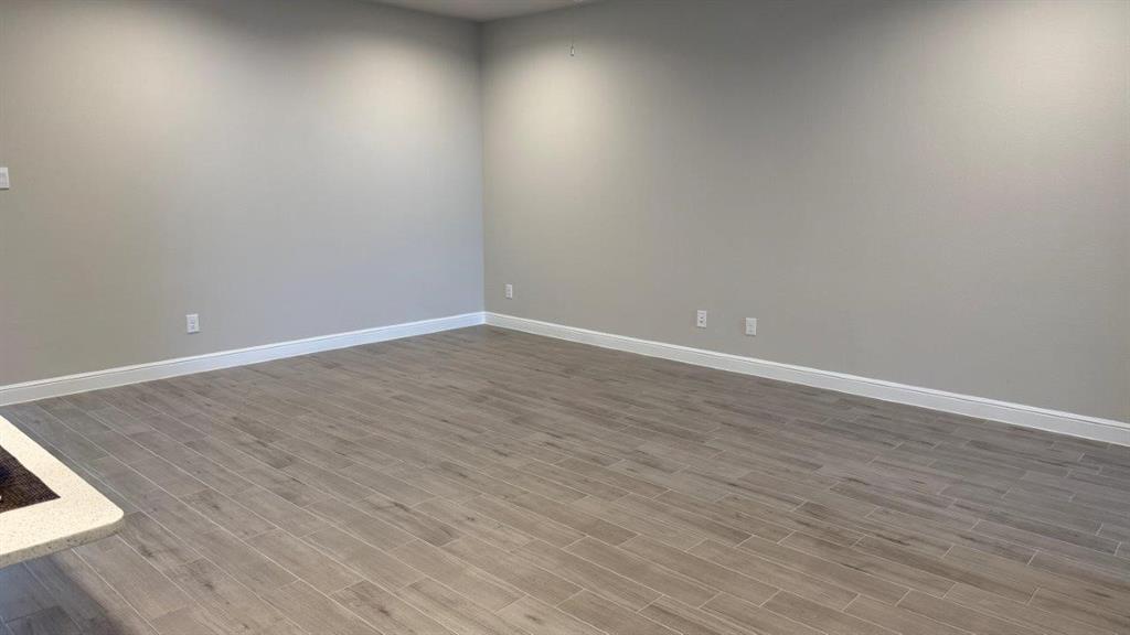 1918 Jackson Street Cleburne, TX 76033 - Photo 3 of 20 a view of an empty room with wooden floor