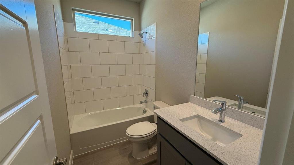 1918 Jackson Street Cleburne, TX 76033 - Photo 7 of 20 a bathroom with a sink a toilet and shower