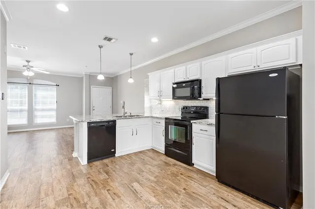 a kitchen with a refrigerator a stove top oven and a center island