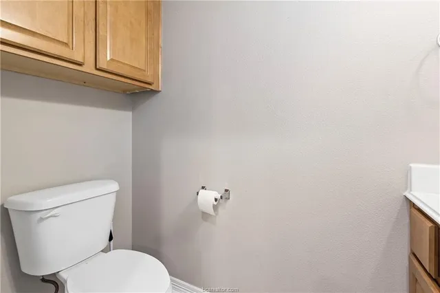 a white toilet sitting next to a sink