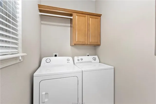 a view of storage and utility room with washer and dryer