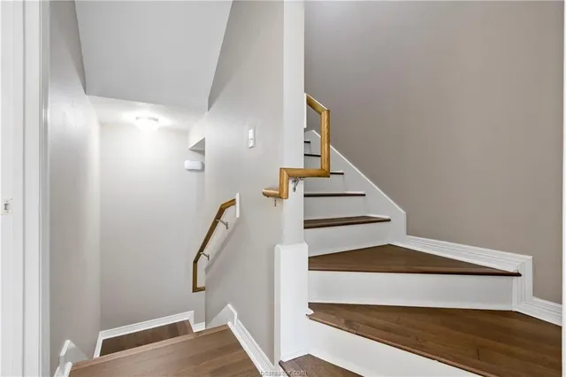 an empty room with chandelier fan and windows
