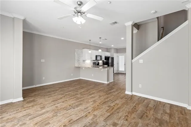 a view of a kitchen with a sink and a refrigerator