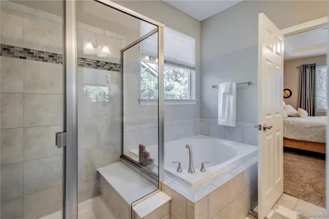 a bathroom with a tub and a shower