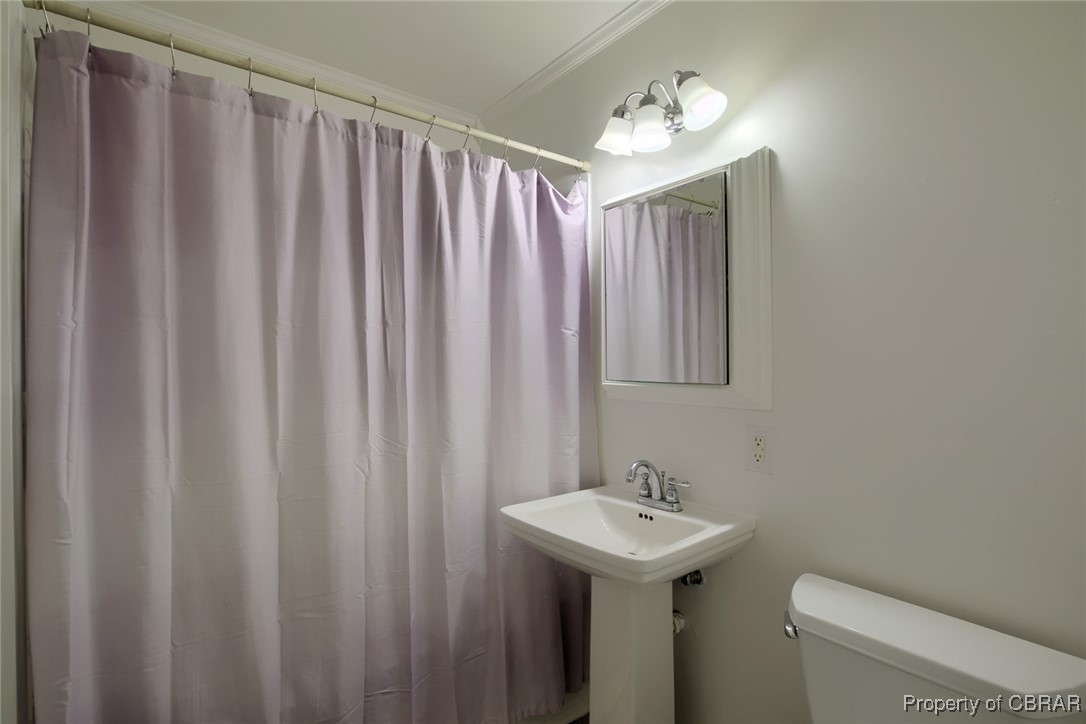 6153 Fletcher Road Gloucester, VA 23061 - Photo 12 of 16 Bathroom with toilet, crown molding, and walk in shower