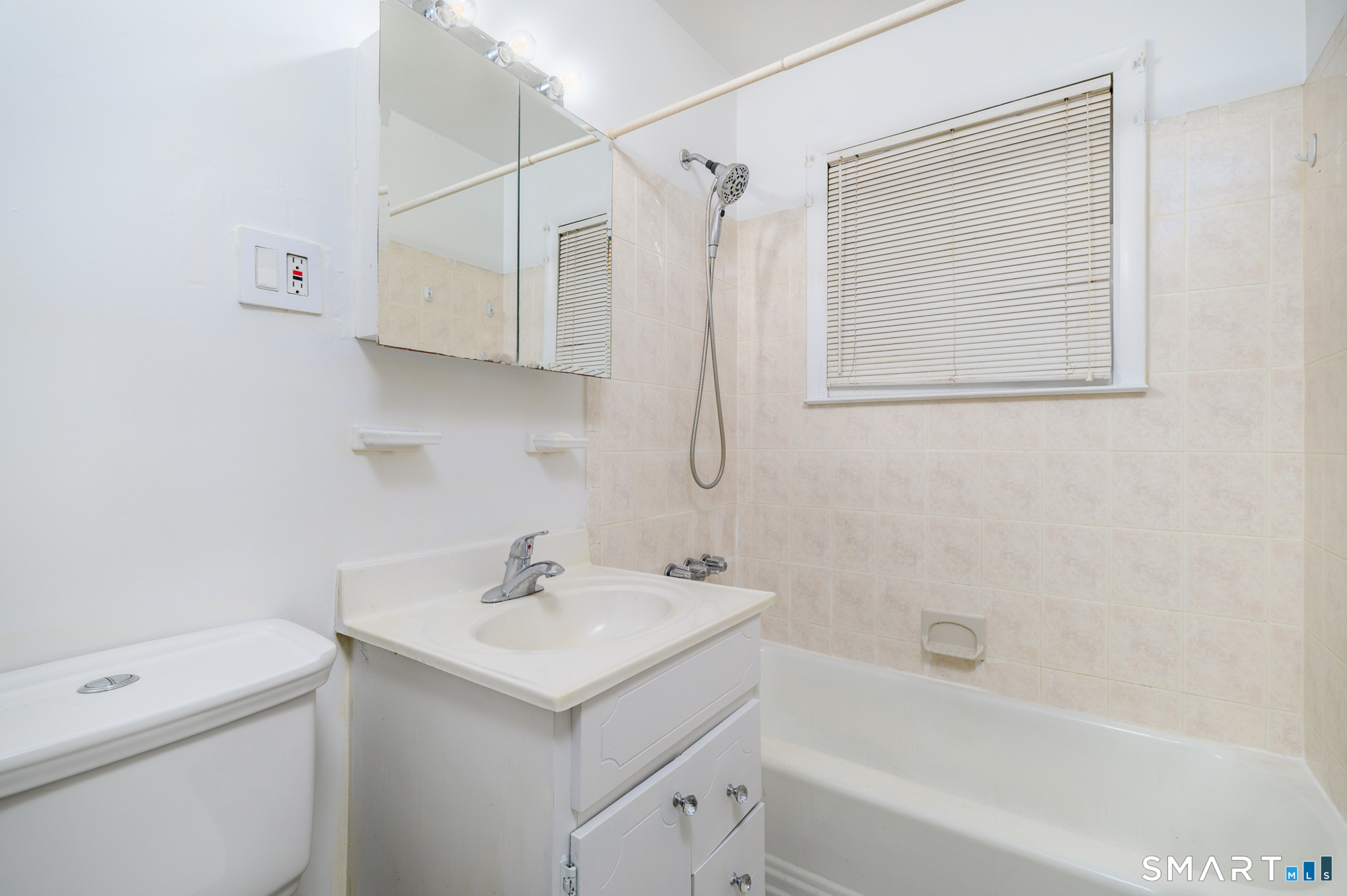 472 Anton Street Bridgeport, CT 06606 - Photo 12 of 23 a bathroom with a sink a toilet and shower