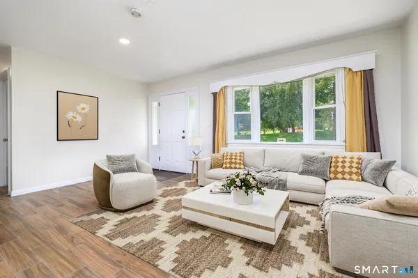 a living room with furniture and a large window