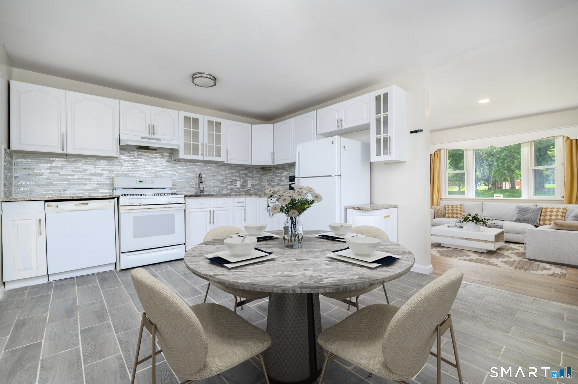 472 Anton Street Bridgeport, CT 06606 - Photo 7 of 23 a kitchen with stainless steel appliances granite countertop a stove a sink dishwasher a dining table and chairs with wooden floor