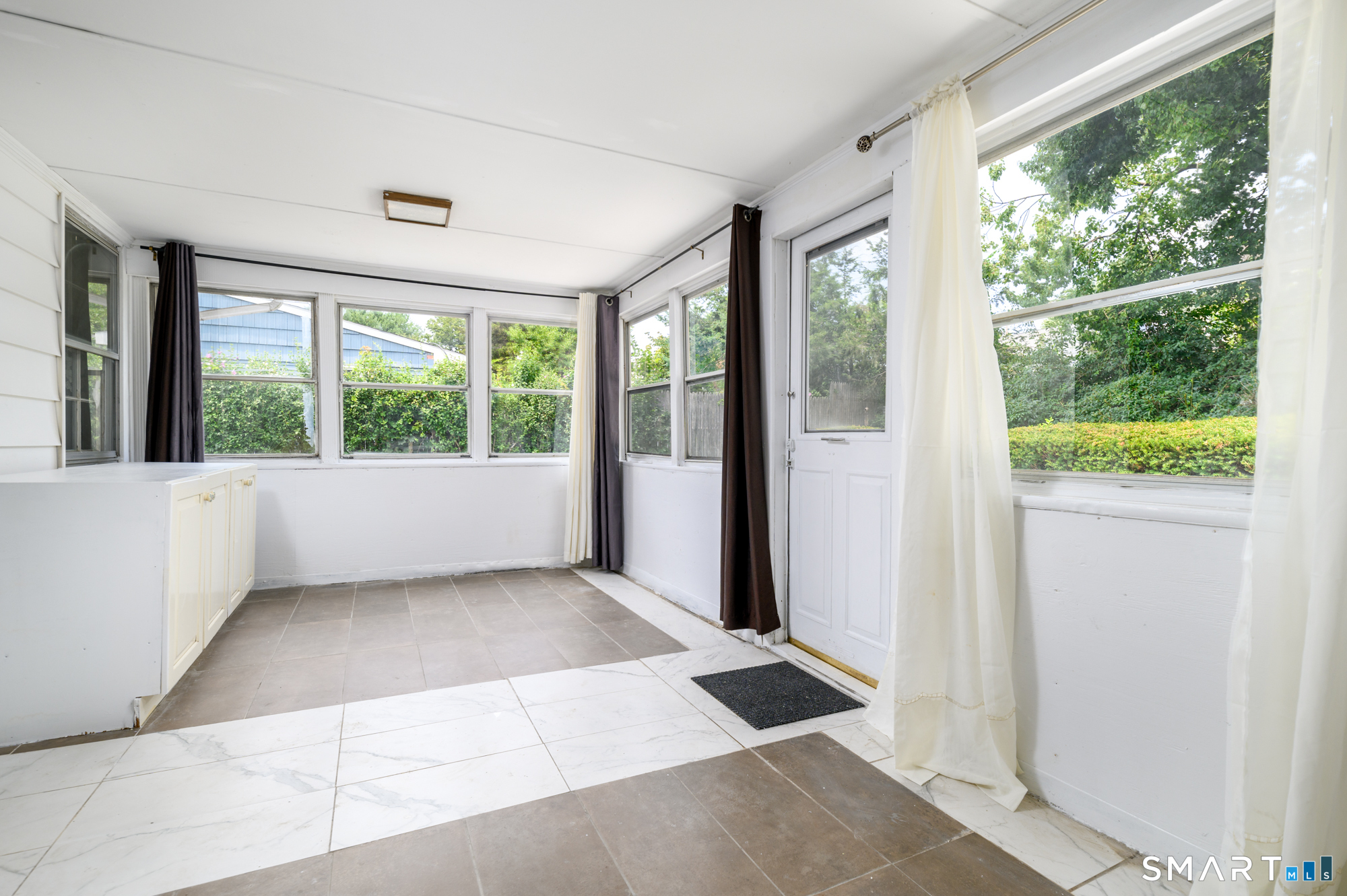 472 Anton Street Bridgeport, CT 06606 - Photo 9 of 23 a view of an empty room with wooden floor and a window