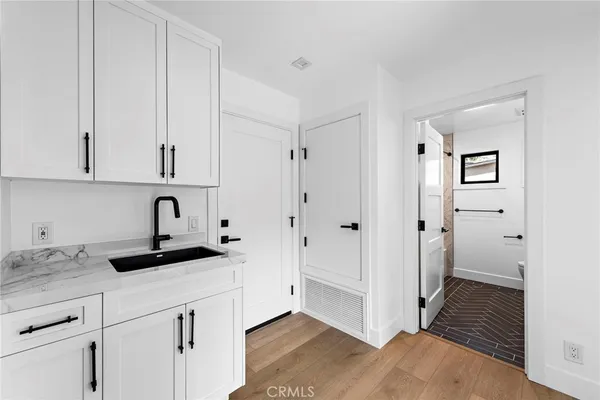 a view of a kitchen with white cabinets