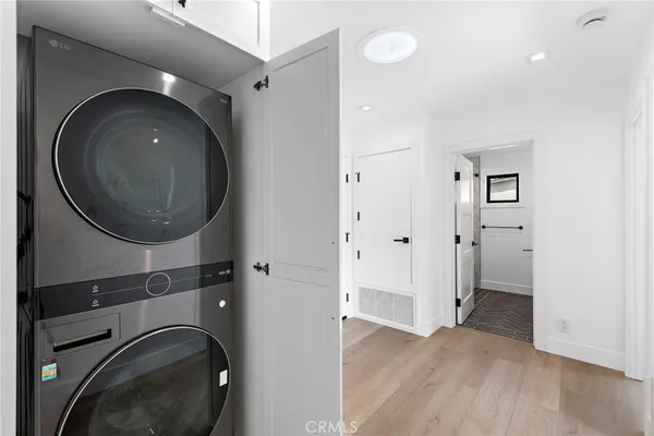 a view of a hallway with washer and dryer