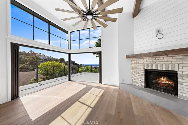 a view of a livingroom with a fireplace and window