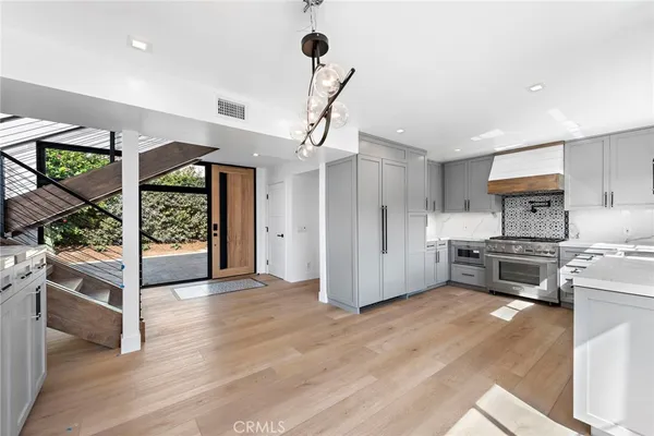 a kitchen with stainless steel appliances a stove and a refrigerator