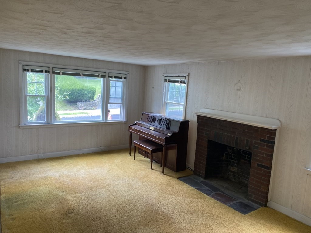 45 Glenellen Road Boston, MA 02132 - Photo 4 of 10 a living room with a fireplace and a window