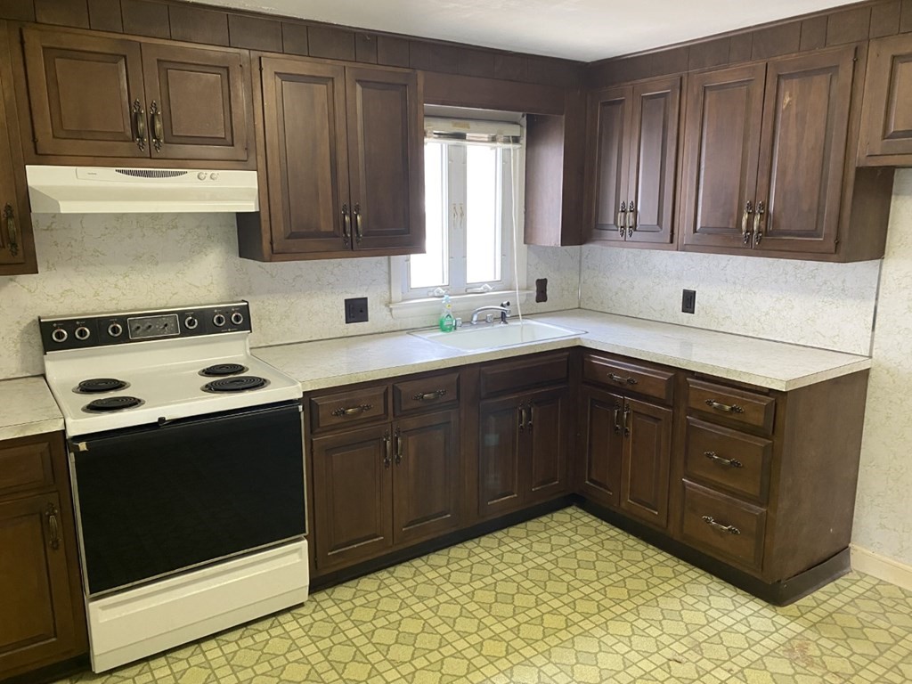 45 Glenellen Road Boston, MA 02132 - Photo 5 of 10 a kitchen with a sink stove and cabinets