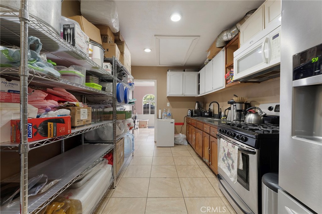 6408 Perry Road Bell Gardens, CA 90201 - Photo 14 of 32 a kitchen with stainless steel appliances granite countertop lots of stainless steel appliances and cabinets