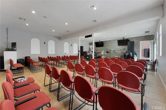 a living room with furniture and kitchen view