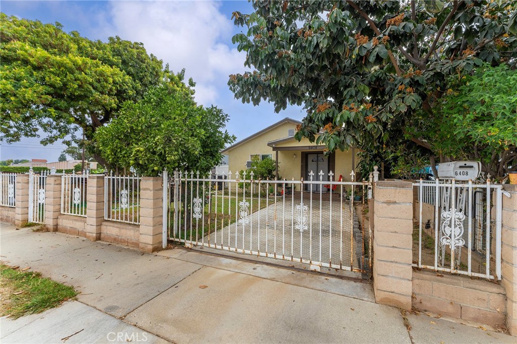 6408 Perry Road Bell Gardens, CA 90201 - Photo 2 of 32 a view of a house with iron fence