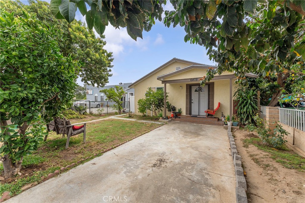 6408 Perry Road Bell Gardens, CA 90201 - Photo 7 of 32 a view of a house with a yard and large tree