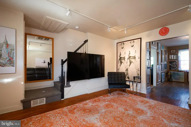 a bedroom with furniture and a wooden floor