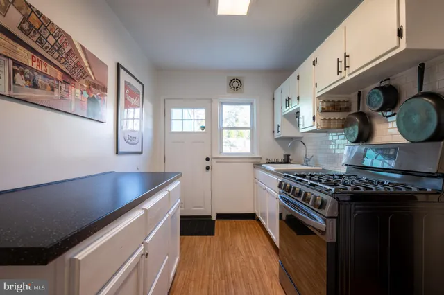 a kitchen with stainless steel appliances granite countertop a stove and a sink