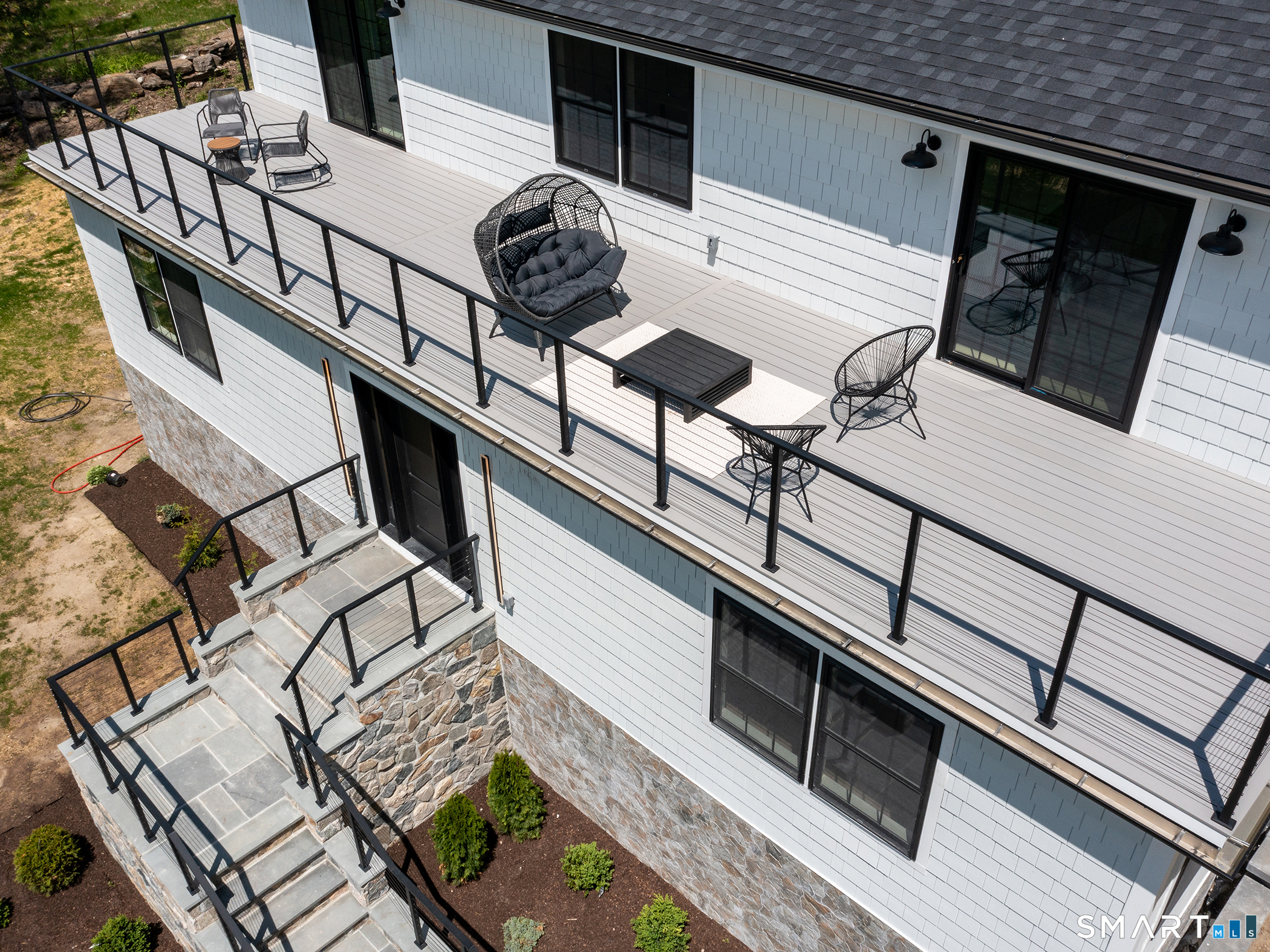 53 Mountain Lake Road Warren, CT 06777 - Photo 38 of 40 a view of a balcony with furniture and lots of frames on wall
