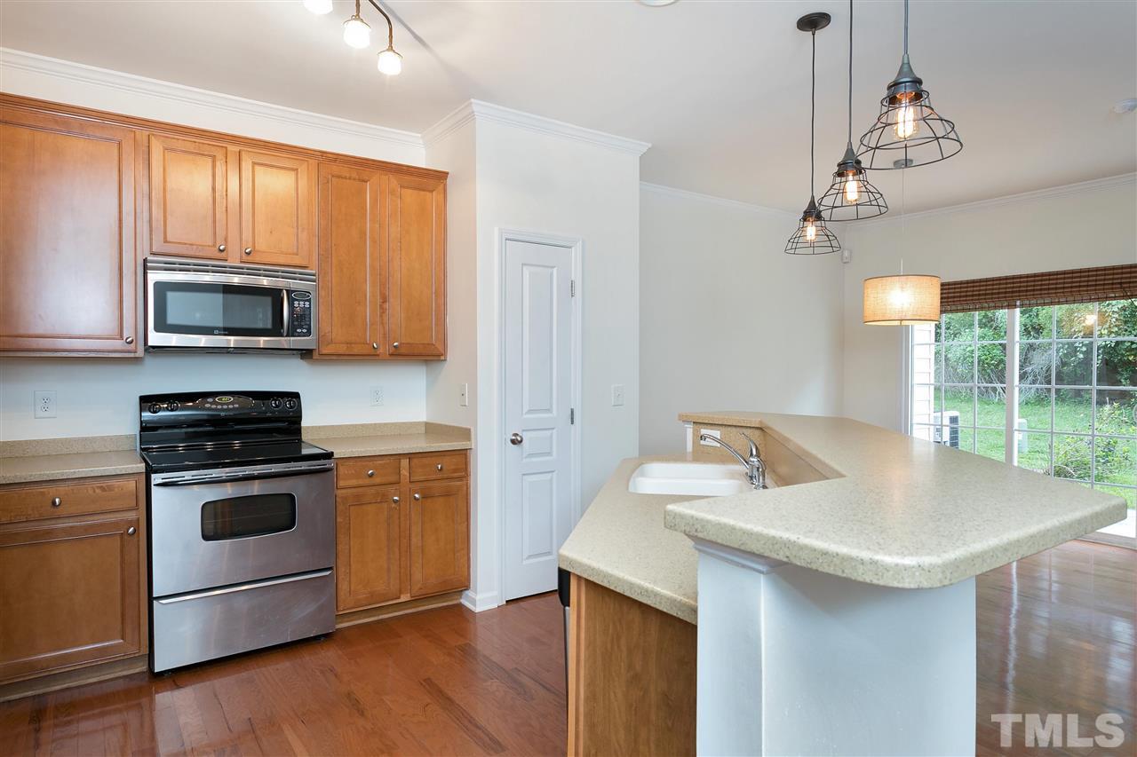 369 Red Elm Drive Durham, NC 27713 - Photo 11 of 29 a kitchen with a stove a sink and a microwave