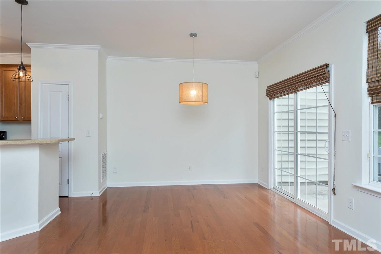 369 Red Elm Drive Durham, NC 27713 - Photo 13 of 29 a view of an empty room with a window and wooden floor