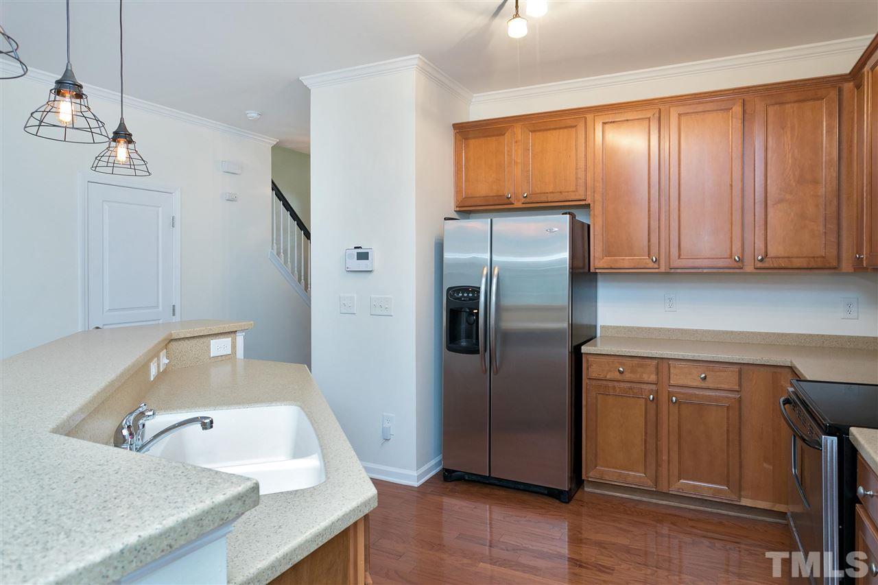 369 Red Elm Drive Durham, NC 27713 - Photo 3 of 29 a kitchen with a refrigerator sink and cabinets