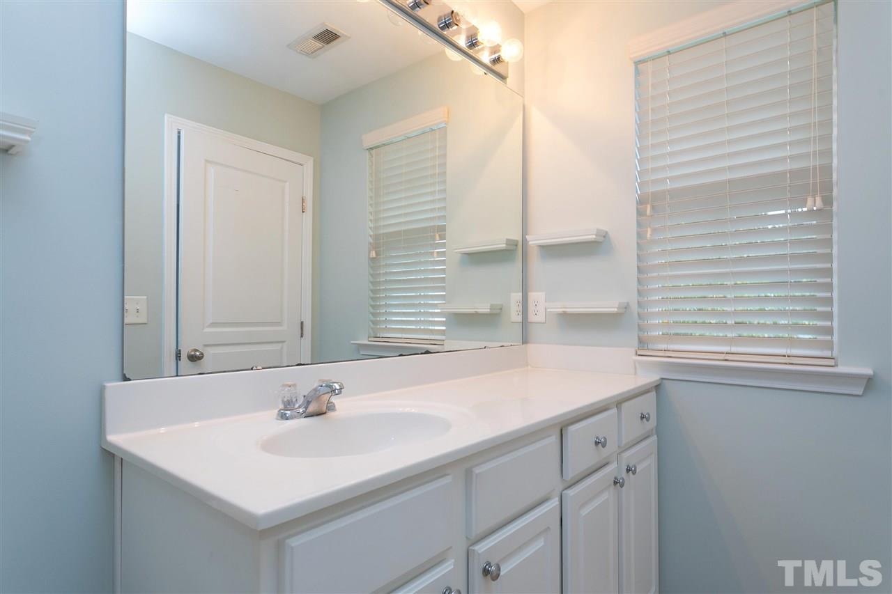 369 Red Elm Drive Durham, NC 27713 - Photo 23 of 29 a bathroom with a sink and a mirror