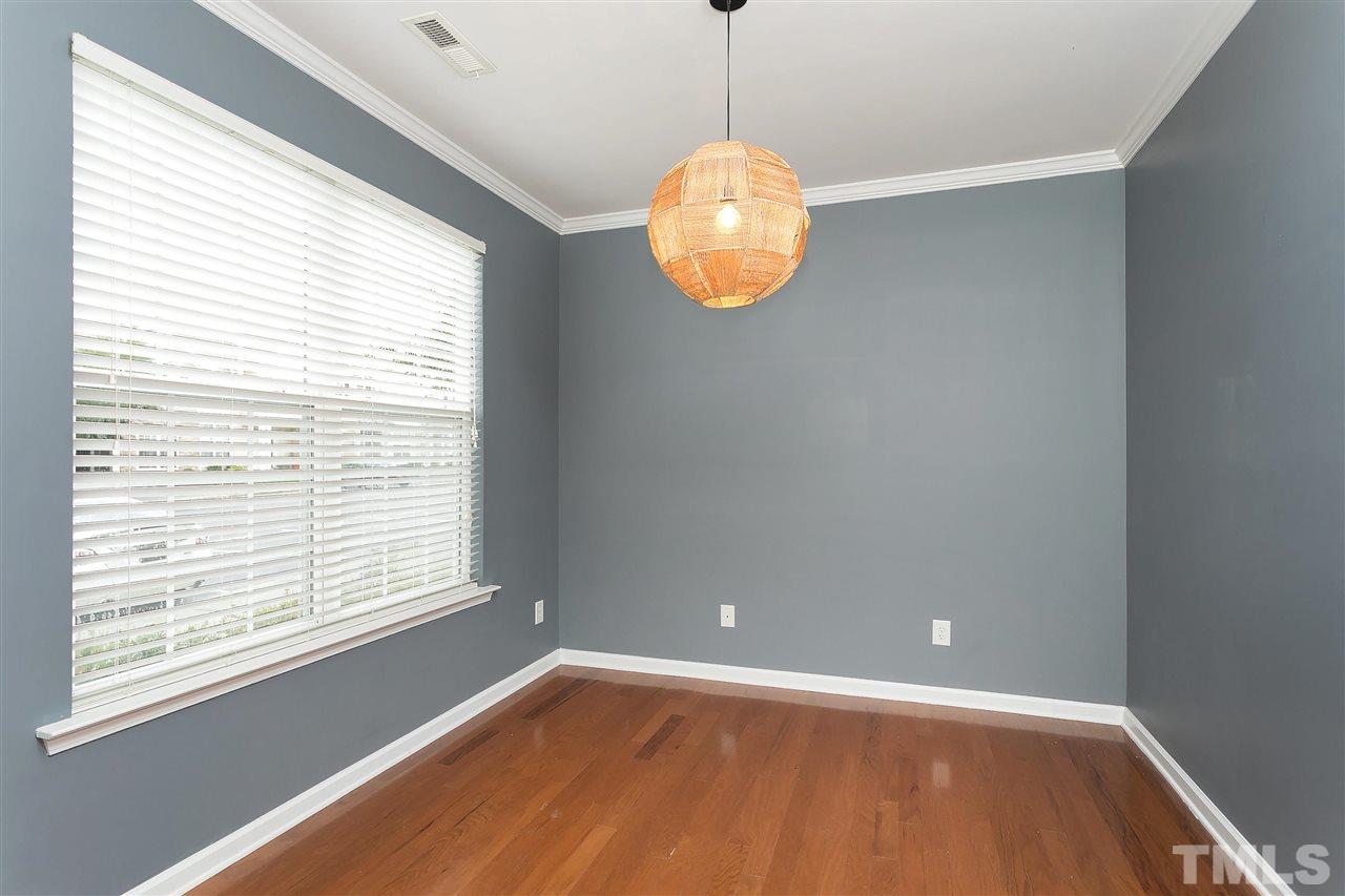 369 Red Elm Drive Durham, NC 27713 - Photo 4 of 29 a view of an empty room with wooden floor and a window