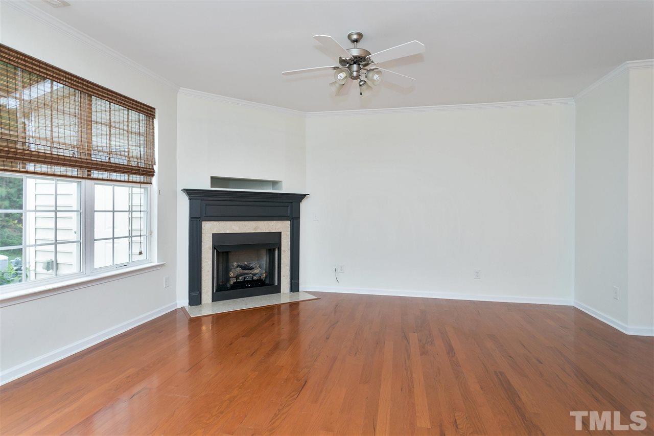 369 Red Elm Drive Durham, NC 27713 - Photo 7 of 29 wooden floor fireplace and windows in an empty room