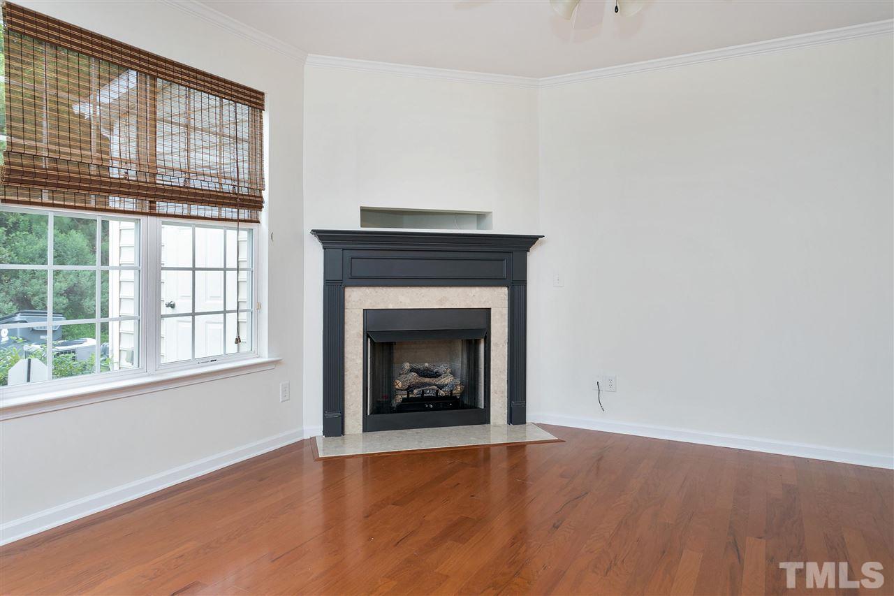 369 Red Elm Drive Durham, NC 27713 - Photo 8 of 29 a view of an empty room with a window and fireplace
