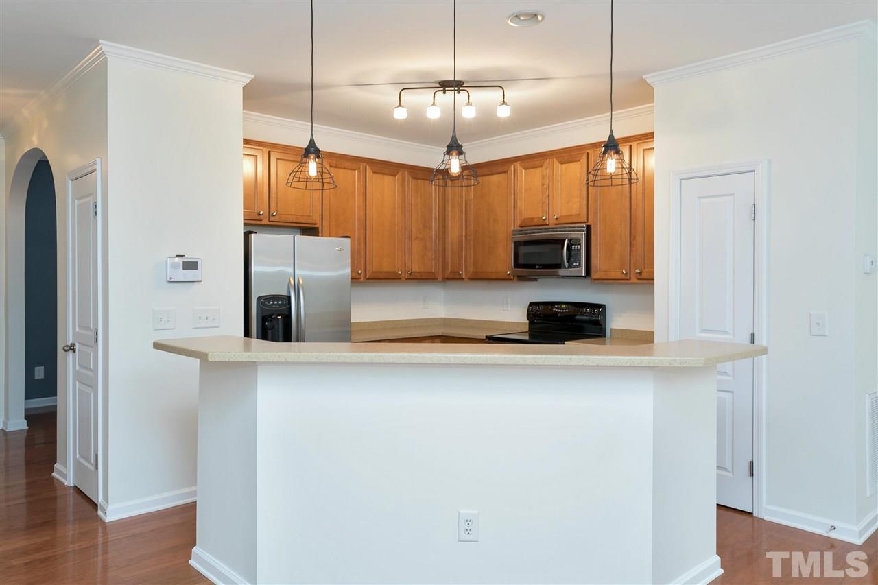 369 Red Elm Drive Durham, NC 27713 - Photo 9 of 29 a kitchen with stainless steel appliances a refrigerator and a stove top oven