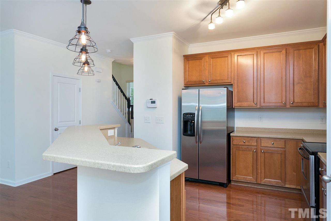 369 Red Elm Drive Durham, NC 27713 - Photo 10 of 29 a kitchen with stainless steel appliances a refrigerator sink and cabinets