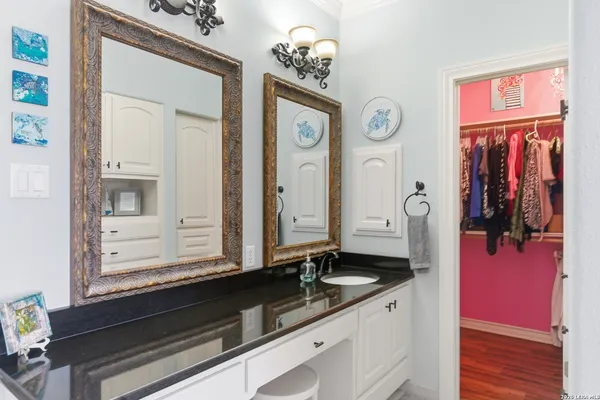 a bathroom with a tub sink and mirror