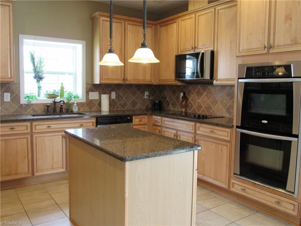 4604 River Valley Road High Point, NC 27265 - Photo 3 of 20 Gourmet kitchen with double oven, built in microwave and cooktop. 42' cabinets will give you all the storage space you need, plus there is a separate pantry.
