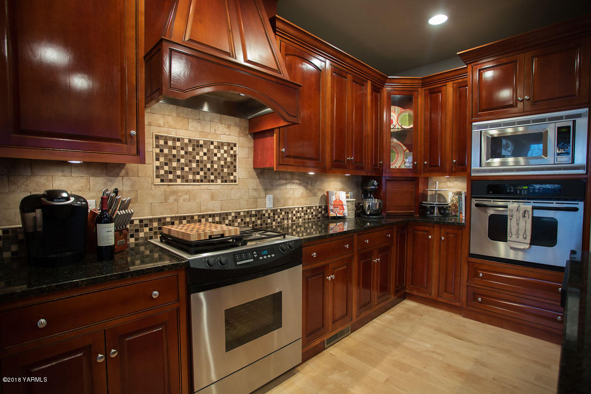 14750 Fisk Road Yakima, WA 98908 - Photo 13 of 35 a kitchen with stainless steel appliances granite countertop a stove a sink and a microwave