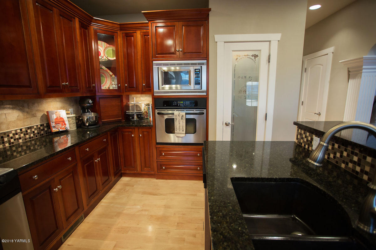 14750 Fisk Road Yakima, WA 98908 - Photo 14 of 35 a kitchen with granite countertop a stove a sink and a microwave