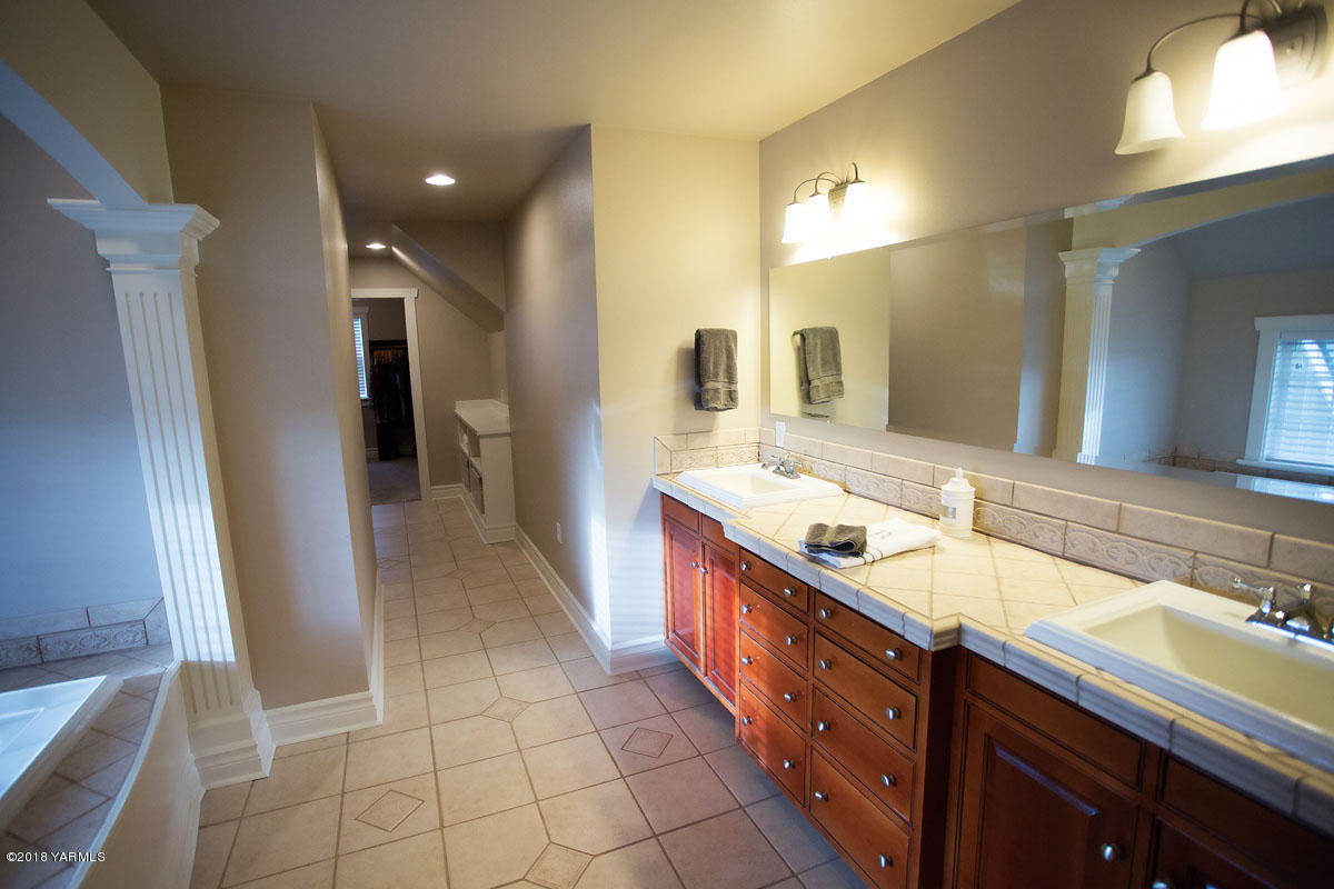 14750 Fisk Road Yakima, WA 98908 - Photo 24 of 35 a spacious bathroom with a double vanity sink a mirror and a shower