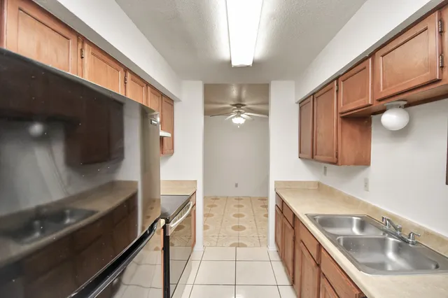 a kitchen with a sink and a refrigerator