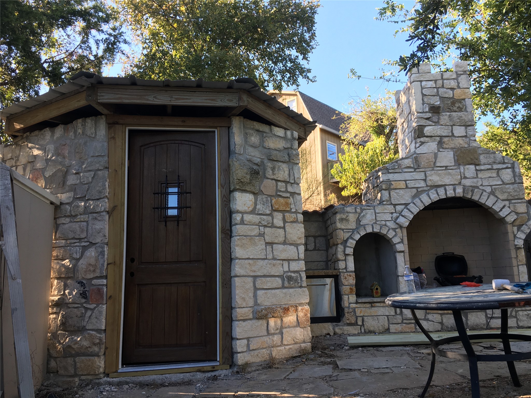 26809 Blue Cove Road Marble Falls, TX 78654 - Photo 16 of 20 Near the entrance to property featuring stone storage building, a stone fireplace, and a patio area
