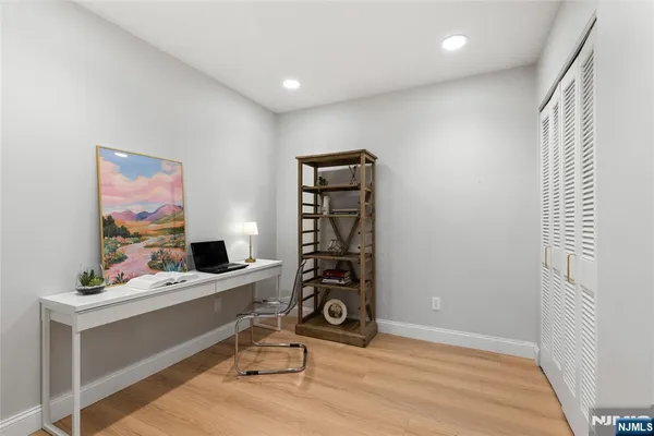 a view of a workspace with furniture and wooden floor