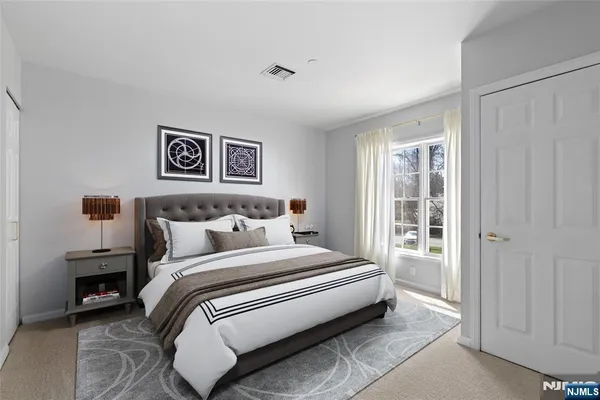 a bedroom with a bed and a night stand