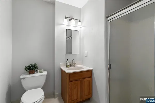 a bathroom with a toilet a sink and mirror