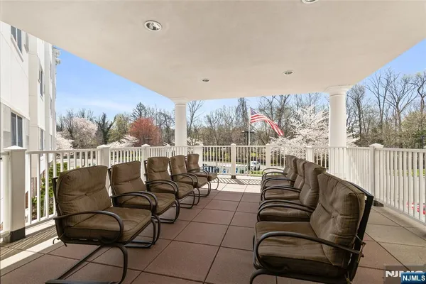 a balcony with furniture and a large window