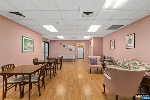 a living room with furniture dining table and a wooden floor